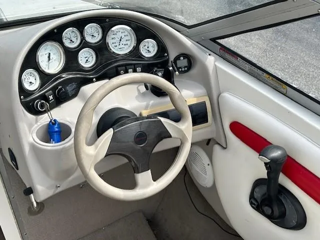 Slide: The Image of Dashboard of a 2004 Stingray 220 CS boat with steering wheel and gauges. - 10