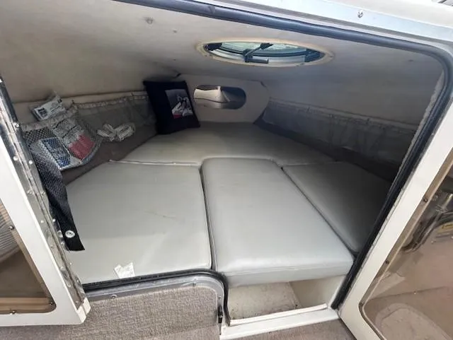 Slide: The Image of 2004 Stingray 220 CS cabin interior with cushioned seating and storage compartments. - 11