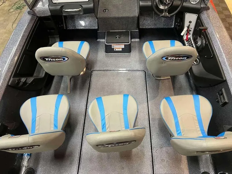 Slide: The Image of 2024 Triton 186 Allure boat interior with four blue-accented seats and steering console. - 4