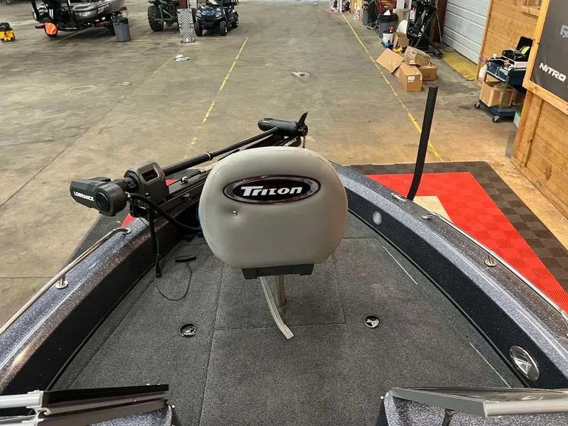 Slide: The Image of 2024 Triton 186 Allure boat interior with Lowrance equipment in a garage setting. - 8