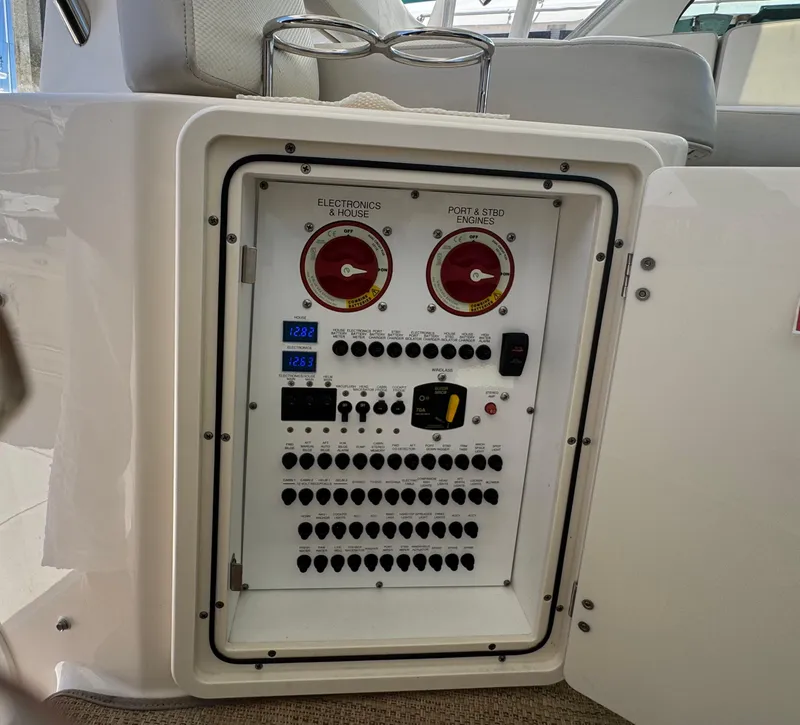 Slide: The Image of Electrical control panel on a 2014 Pursuit 345 OS boat, featuring switches and gauges. - 21