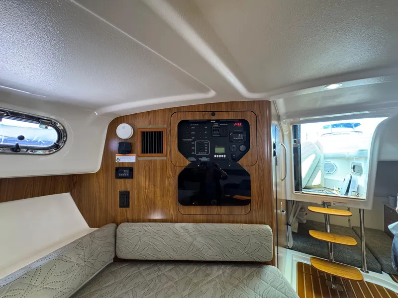 Slide: The Image of 2014 Pursuit 345 OS cabin interior with control panel and seating area. - 22