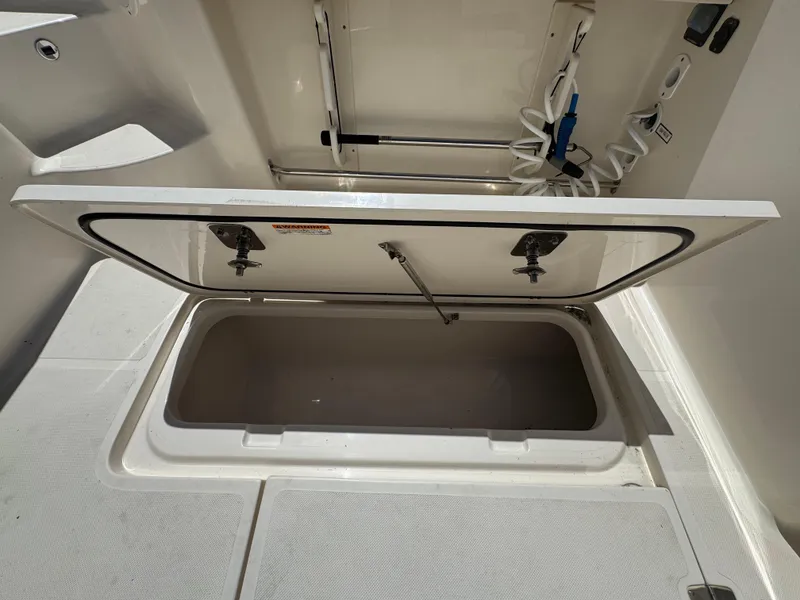 Slide: The Image of Open storage compartment on a 2014 Pursuit 345 OS boat, showcasing interior space. - 25