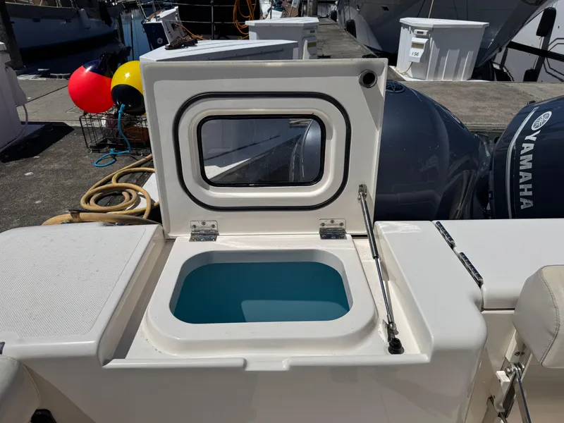 Slide: The Image of 2014 Pursuit 345 OS boat with open hatch and Yamaha engines in marina. - 27