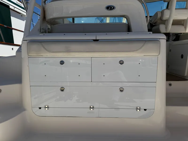 Slide: The Image of 2014 Pursuit 345 OS boat interior with storage compartments and seating. - 30