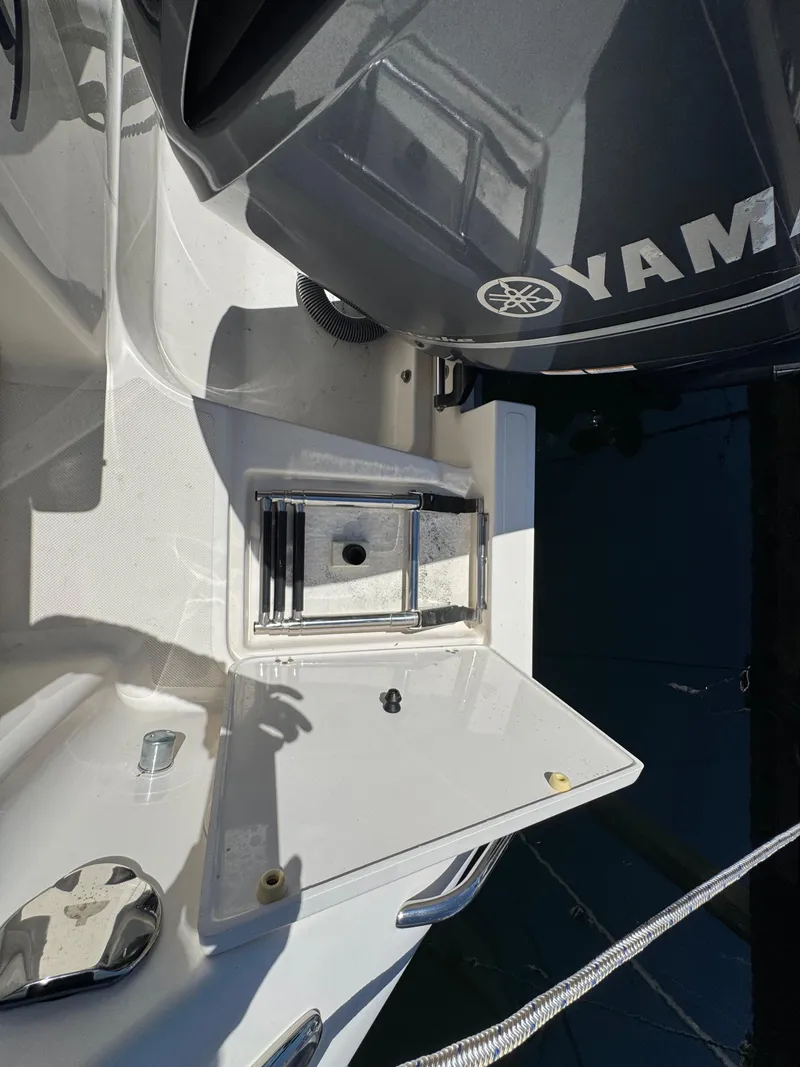 Slide: The Image of 2014 Pursuit 345 OS boat with Yamaha engine and open hatch. - 31