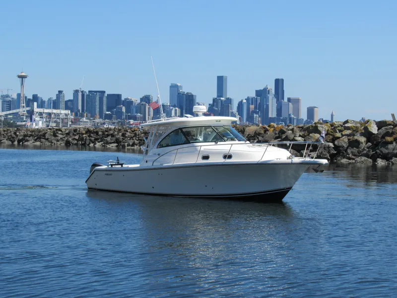 Slide: The Image of 2014 Pursuit 345 OS boat on water with city skyline in background. - 32
