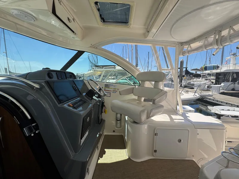 Slide: The Image of Interior view of 2014 Pursuit 345 OS boat cockpit with helm and seating. - 5