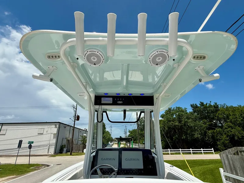 Slide: The Image of 2023 Sea Hunt Ultra 255 SE boat console with Garmin electronics, rod holders, and speakers. - 11