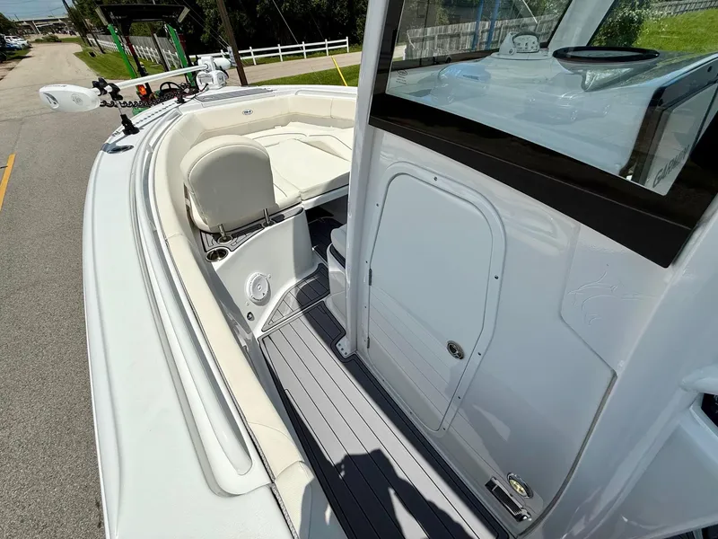 Slide: The Image of 2023 Sea Hunt Ultra 255 SE boat interior with seating and console view. - 12
