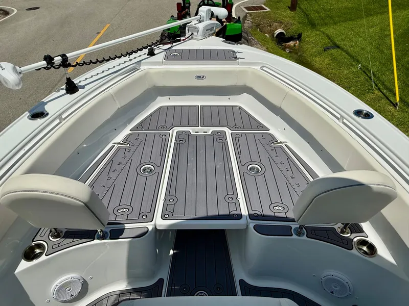 Slide: The Image of 2023 Sea Hunt Ultra 255 SE boat interior with cushioned seating and sleek deck design. - 15
