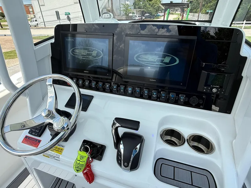 Slide: The Image of 2023 Sea Hunt Ultra 255 SE boat dashboard with dual Garmin displays and steering wheel. - 18