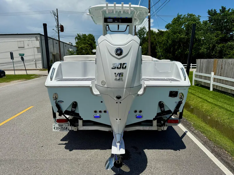 Slide: The Image of 2023 Sea Hunt Ultra 255 SE boat with powerful outboard motor on a sunny street. - 3