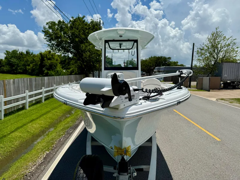 Slide: The Image of 2023 Sea Hunt Ultra 255 SE boat on trailer, parked on a sunny road. - 6
