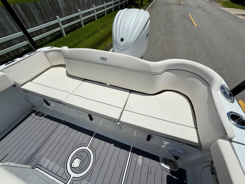 Slide: The Image of 2023 Sea Hunt Ultra 255 SE boat interior with white seating and sleek flooring. - 7