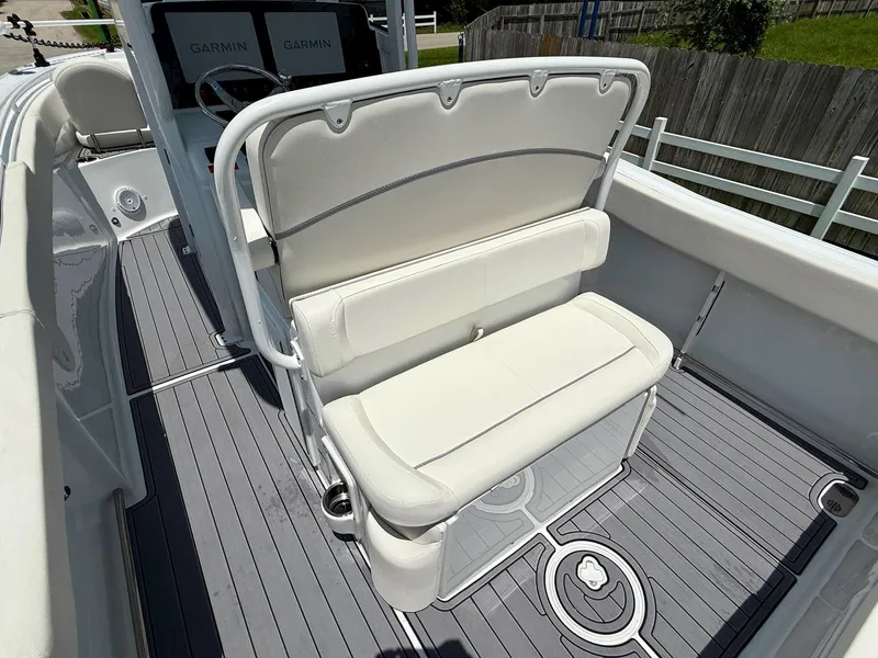 Slide: The Image of 2023 Sea Hunt Ultra 255 SE boat interior with white seating and Garmin navigation system. - 8