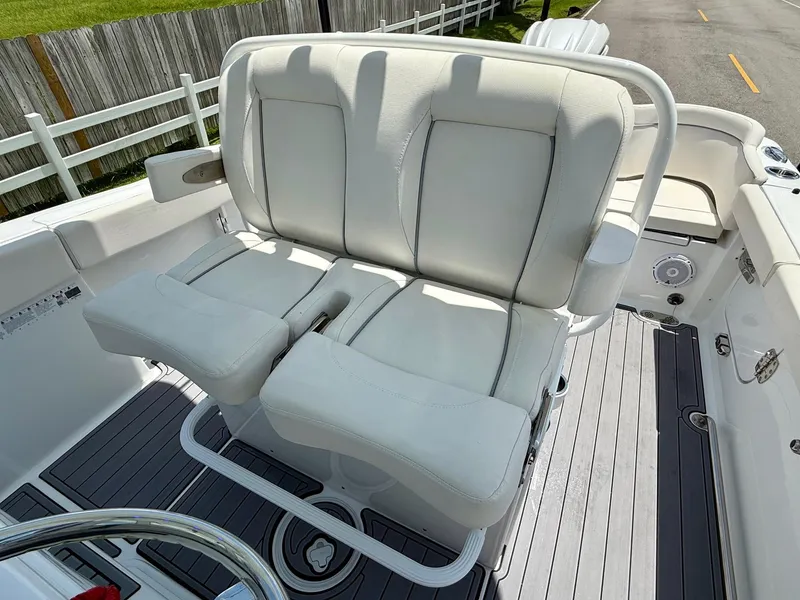 Slide: The Image of 2023 Sea Hunt Ultra 255 SE boat seating with white cushions and sleek design. - 9