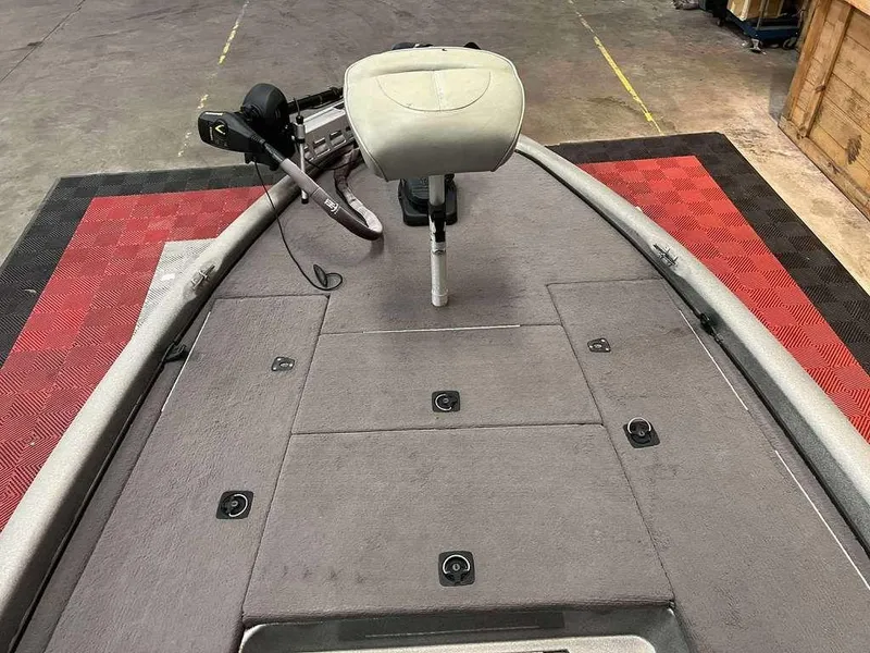 Slide: The Image of 2000 Triton TR20 boat deck with seat and trolling motor in a garage setting. - 10