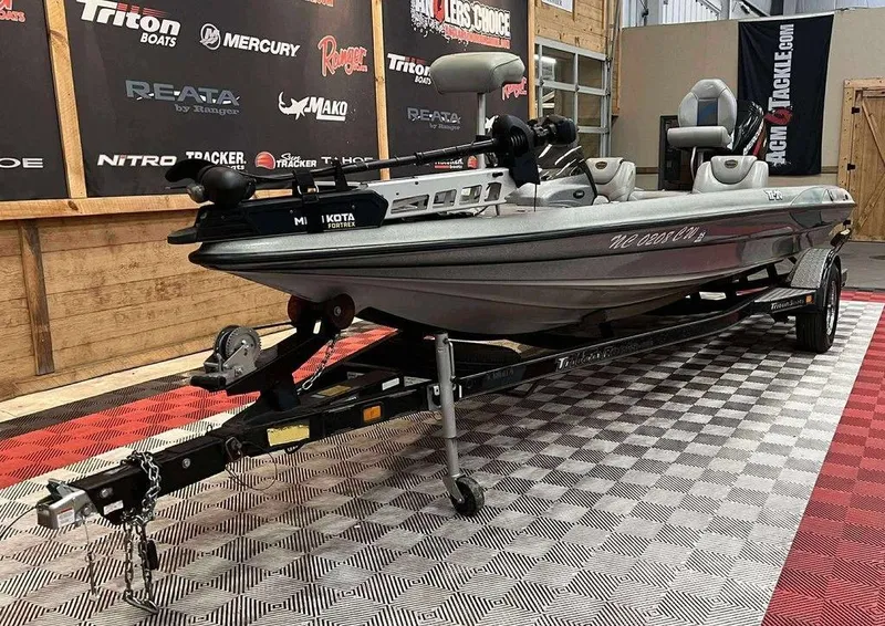 Slide: The Image of 2000 Triton TR20 boat on trailer in showroom with branded backdrop. - 4