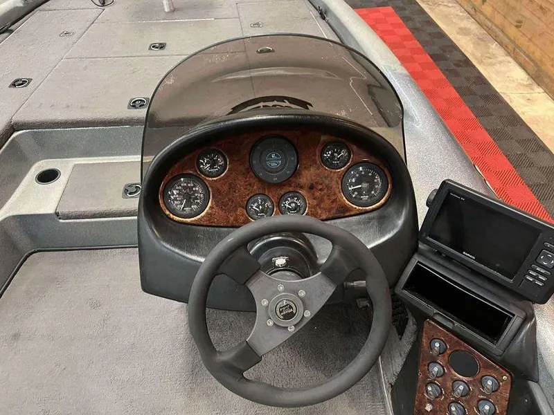 Slide: The Image of 2000 Triton TR20 boat dashboard with steering wheel, gauges, and Garmin navigation system. - 7