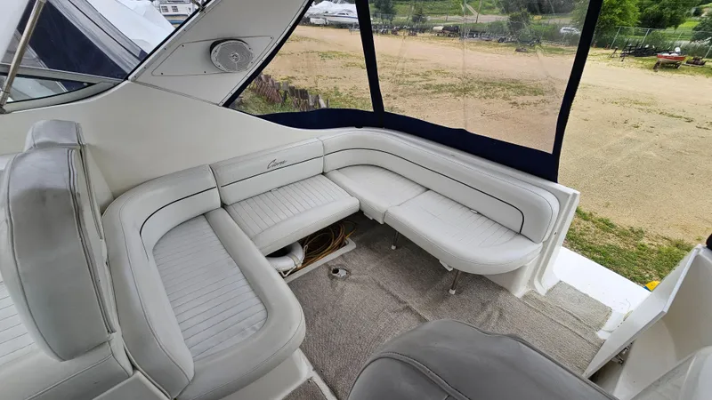 Slide: The Image of Interior of a 1999 Bayliner 3055 Ciera boat with white seating and carpeted floor. - 5