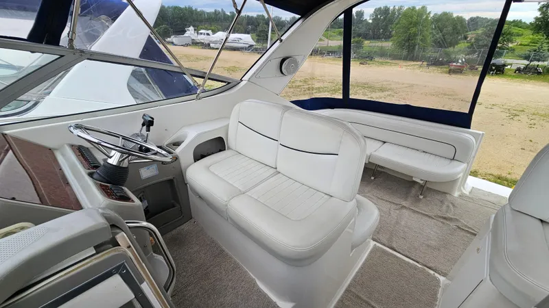 Slide: The Image of 1999 Bayliner 3055 Ciera boat interior with white seating and steering wheel. - 7