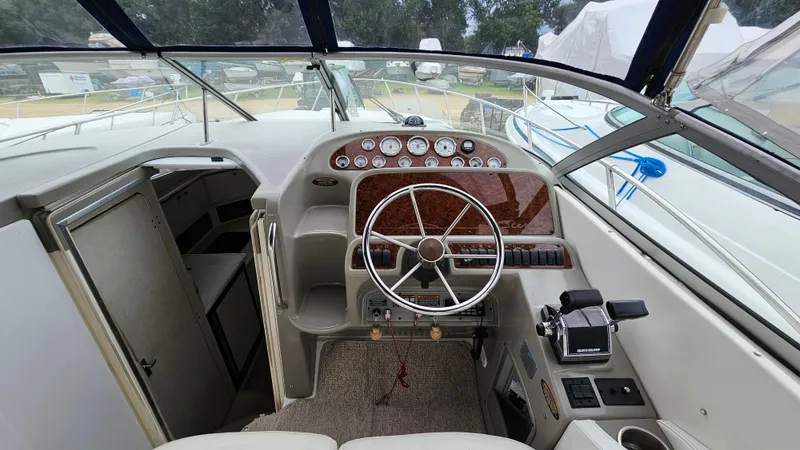 Slide: The Image of 1999 Bayliner 3055 Ciera cockpit with steering wheel, control panel, and gauges. - 9