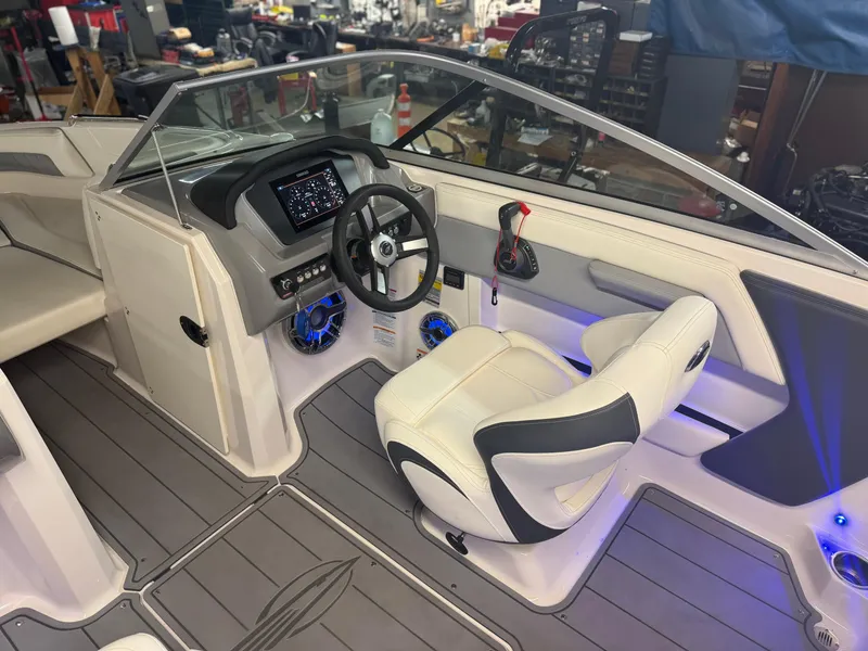 Slide: The Image of 2023 Chaparral 21 Surf boat interior with modern dashboard and white seating. - 11
