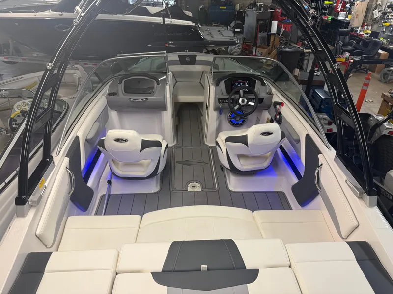 Slide: The Image of 2023 Chaparral 21 Surf boat interior with modern seating and illuminated dashboard. - 17