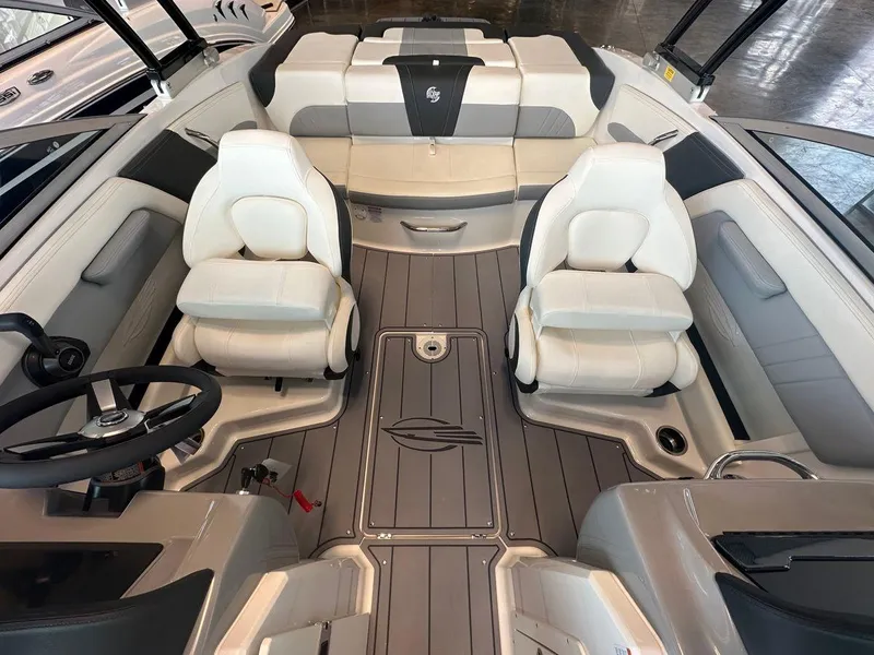 Slide: The Image of 2023 Chaparral 21 Surf boat interior with white seating and sleek design. - 5