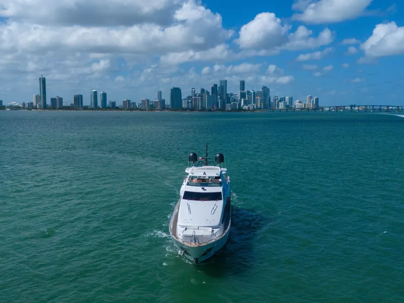 Slide: The Image of Azimut Grande 105 yacht cruising near city skyline under blue sky, 2012 model. - 19