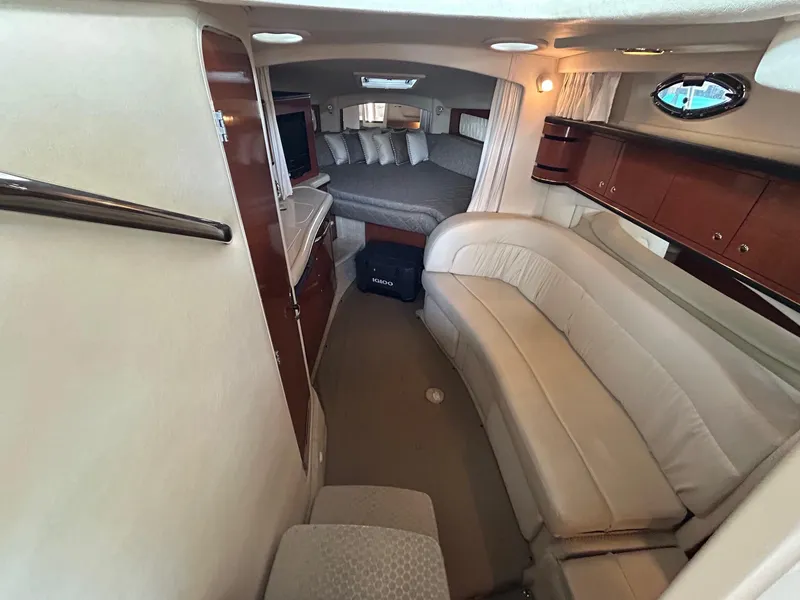Slide: The Image of Interior of 2002 Sea Ray 300 Sundancer yacht with cozy seating and sleeping area. - 18