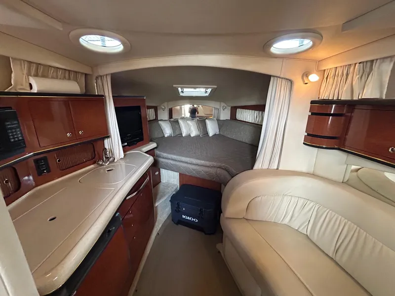 Slide: The Image of Interior of 2002 Sea Ray 300 Sundancer yacht with cozy cabin and kitchenette. - 19