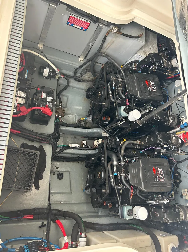 Slide: The Image of Engine compartment of a 2002 Sea Ray 300 Sundancer boat, showing dual engines and wiring. - 27