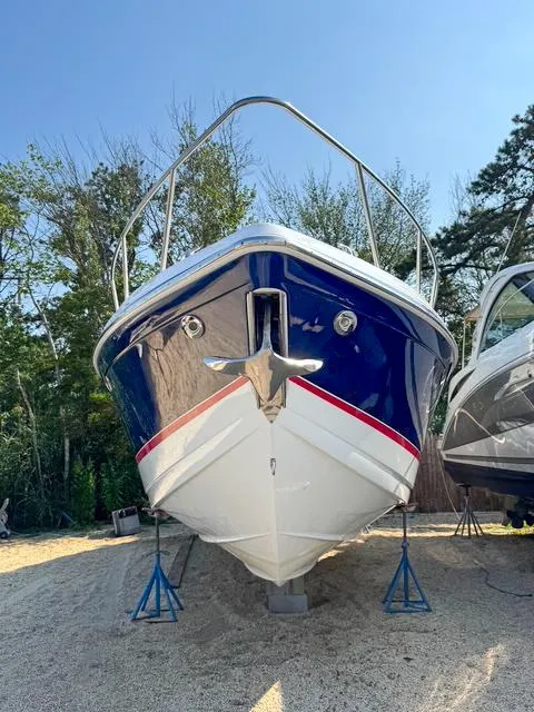 Slide: The Image of 2009 Formula 400ss boat on stands, front view, outdoors with trees in background. - 10