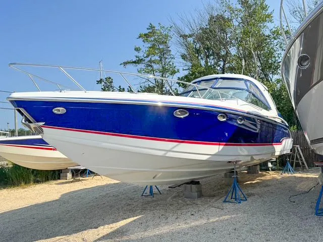 Slide: The Image of 2009 Formula 400ss boat on stands, blue and white hull, parked outdoors. - 11