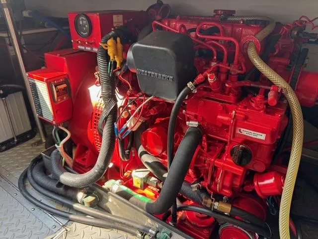 Slide: The Image of Red engine in a 2009 Formula 400ss boat, featuring complex wiring and components. - 12