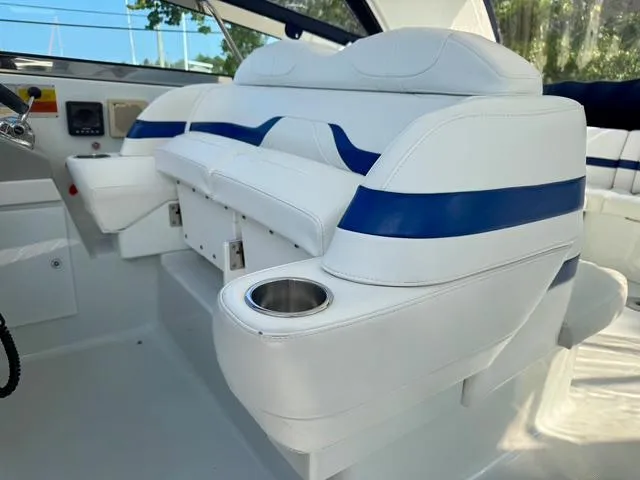 Slide: The Image of 2009 Formula 400ss boat interior with white and blue seating, cup holder, and control panel. - 20