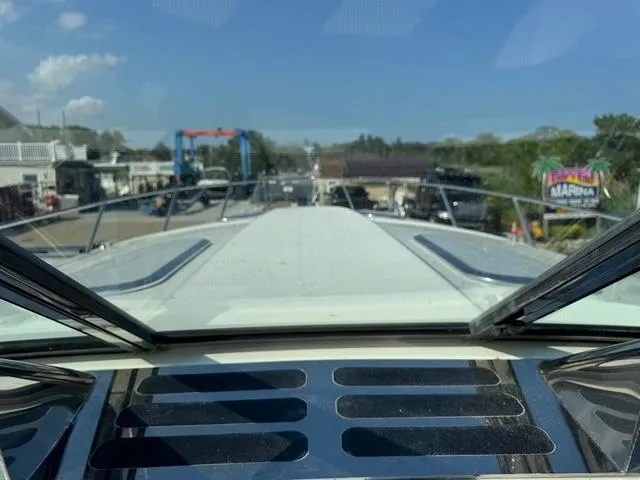 Slide: The Image of Front view of a 2009 Formula 400ss boat at a marina under a clear blue sky. - 23