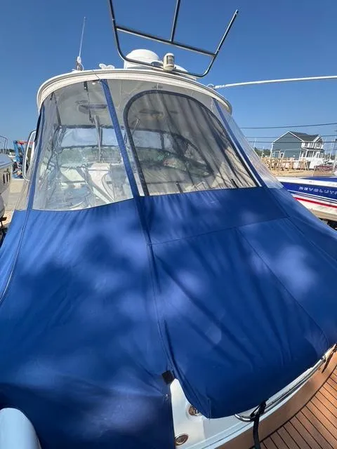 Slide: The Image of 2009 Formula 400ss boat with blue cover docked under clear sky. - 28