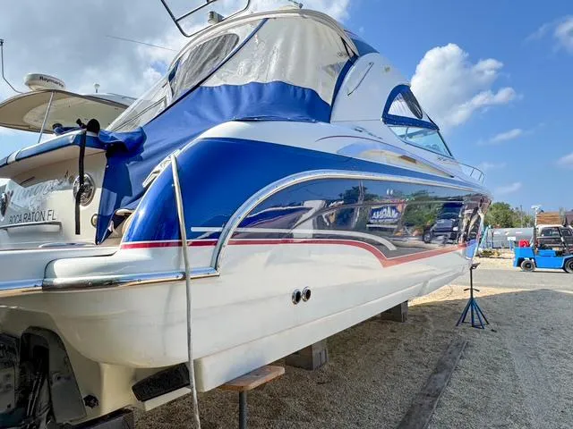 Slide: The Image of 2009 Formula 400ss boat on dry dock, blue and white design, sunny day. - 3