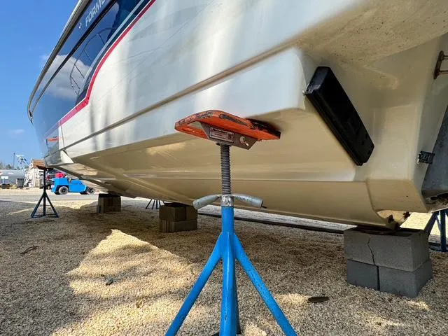 Slide: The Image of 2009 Formula 400ss boat on stands, under maintenance, with clear blue sky background. - 32