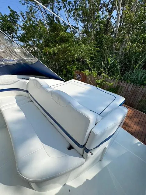 Slide: The Image of 2009 Formula 400ss boat with white seating, surrounded by lush greenery. - 34