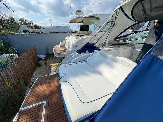 Slide: The Image of 2009 Formula 400ss yacht with white seating and wooden deck, docked outdoors. - 35