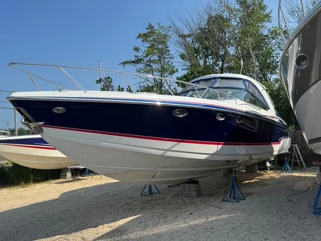 Slide: The Image of 2009 Formula 400ss boat on stands, blue and white hull, outdoors. - 4
