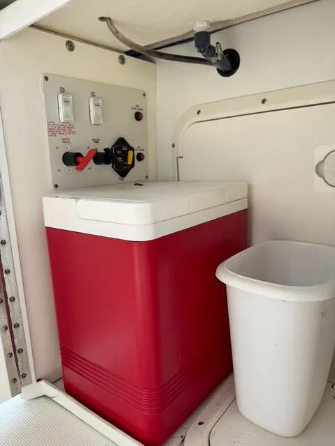 Slide: The Image of Red cooler and white trash bin inside a 2009 Formula 400ss boat compartment. - 40