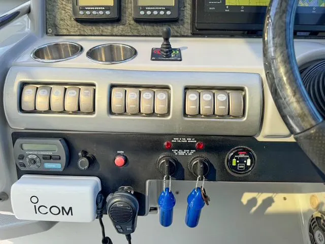 Slide: The Image of Control panel of a 2009 Formula 400ss boat with switches and ICOM radio. - 44