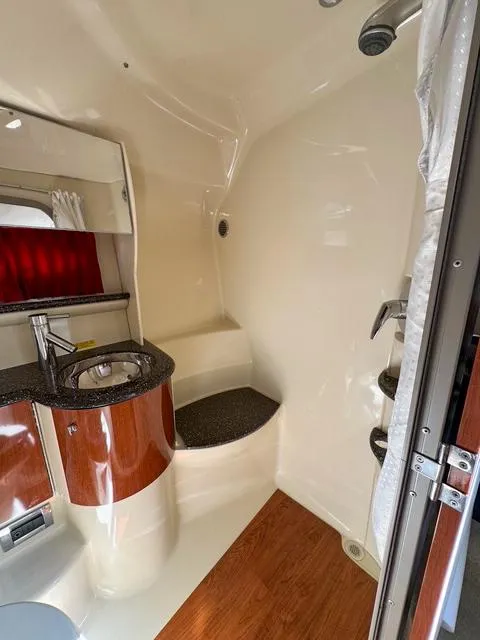 Slide: The Image of 2009 Formula 400ss boat interior bathroom with sink, shower, and wood accents. - 47