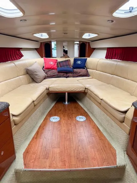 Slide: The Image of Luxurious interior of a 2009 Formula 400ss boat with beige seating and decorative pillows. - 48