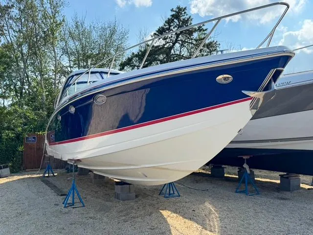 Slide: The Image of 2009 Formula 400ss boat on stands, blue and white hull, outdoor display. - 5